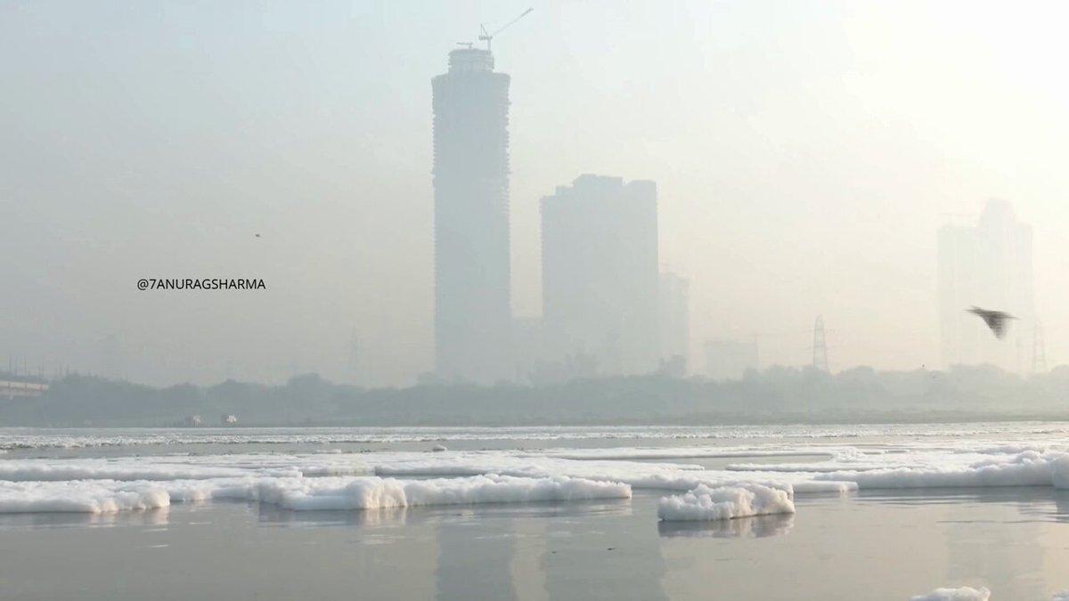 Thick white foam covers the Yamuna River near Kalindi Kunj as severe toxic pollution worsens. Urgent action and strict environmental oversight are needed to protect the ecosystem and public health.