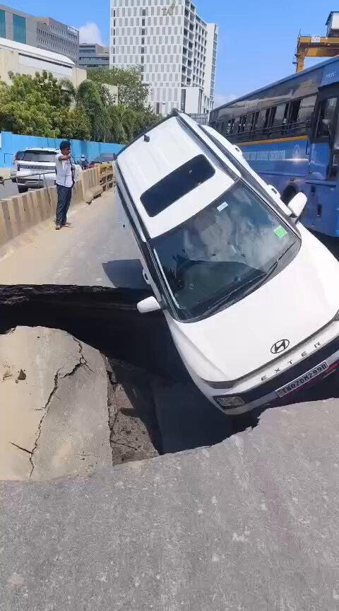 Car topples in OMR after road caves in