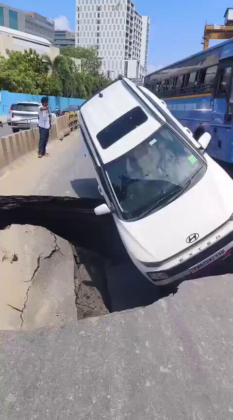 Car plunges into sinkhole after OMR section caves in near Tidel Park in Chennai. The two occupants escaped unhurt. The incident occurred close to an underground Metro construction site near Tidel Park