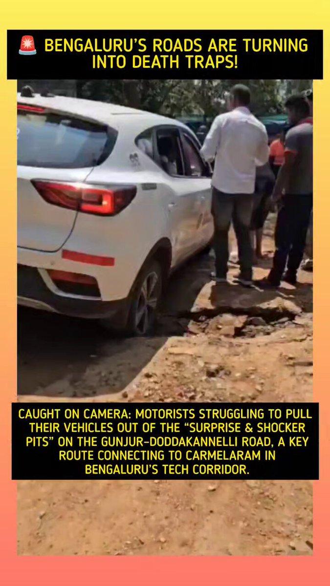 🚨 Bengaluru’s roads are turning into death traps! Caught on camera: Motorists struggling to pull their vehicles out of the “surprise & shocker pits” on the Gunjur–Doddakannelli Road,