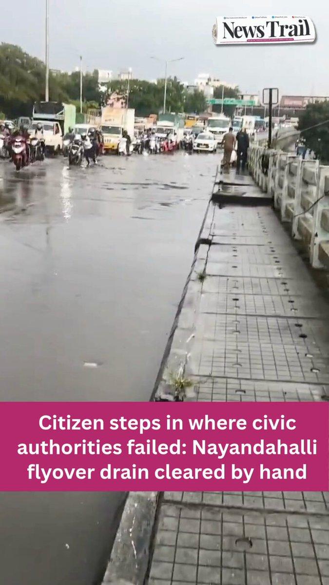After rainwater clogged the Nayandahalli flyover yesterday, a citizen identified as Shivakumar reportedly climbed into a blocked drain and cleared the accumulated filth himself, helping traffic move a
