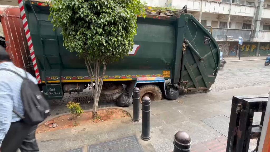 RT by @prameshjain12: White topping road on Church Street caves in, leaving a garbage truck stuck at the spot.